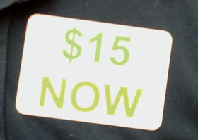 Stickers like this one adored the shirts, sweaters and jackets of the dozens of Living Wage advocates who thronged to the Sonoma County Board of Supervisors meeting Tuesday afternoon.